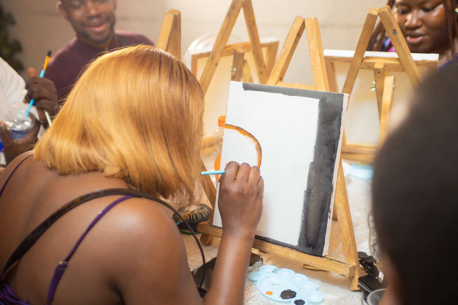 A group of adults painting together during a creative workshop