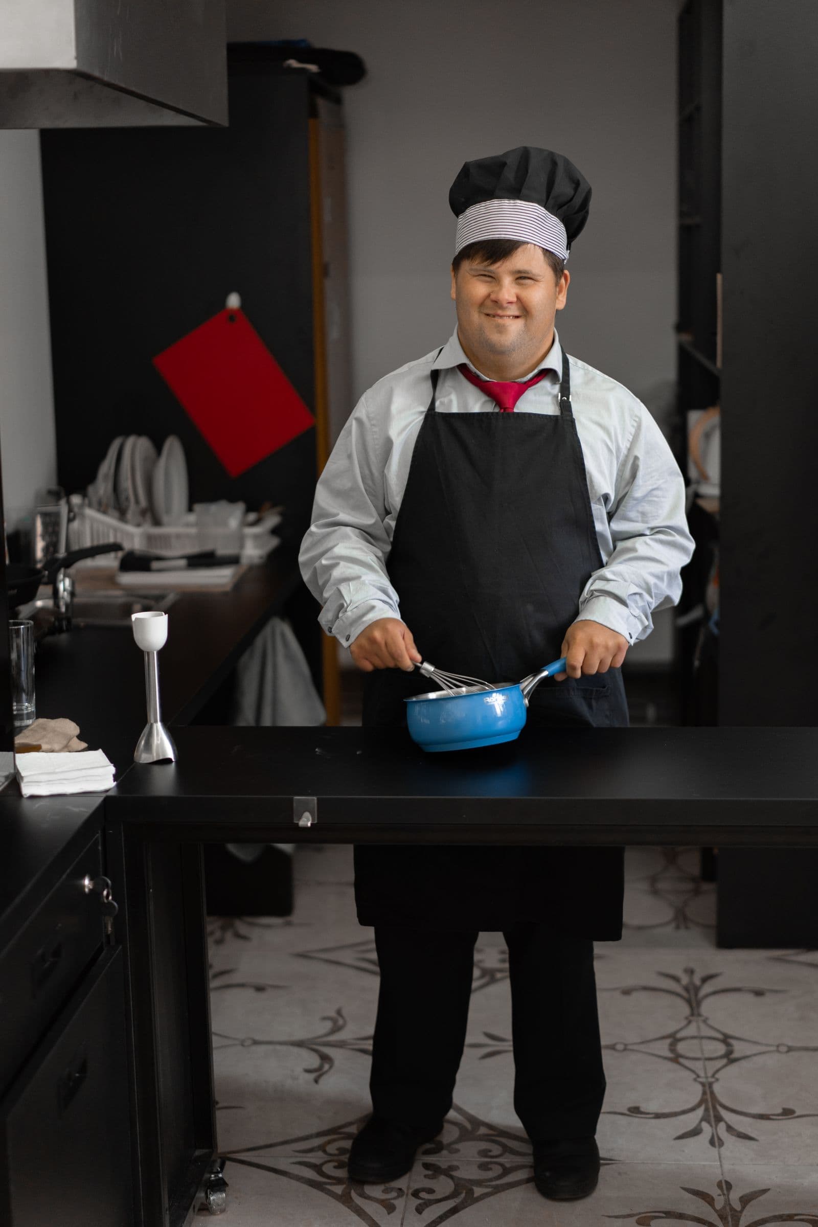 A smiling chef with Down syndrome building healthy cooking skills